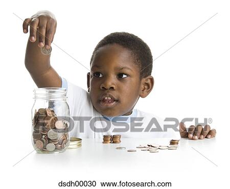 Close-up of a boy collecting coins in a jar View Large Photo Image Stock Image - Close-up of a boy collecting coins in a jar. Fotosearch