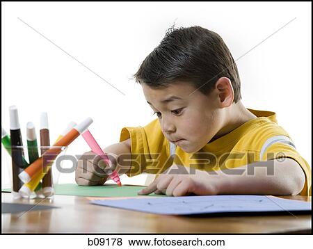 Close-up of a boy drawing with a felt tip pen View Large Photo Image Stock Photo - Close-up of a boy drawing with a felt tip pen. Fotosearch
