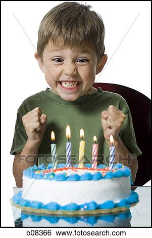 Close-up of a boy in front of a birthday cake View Large Photo Image Stock Photograph - Close-up of a boy in front of a birthday cake. Fotosearch