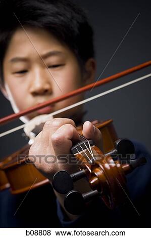 Close-up of a boy playing the violin View Large Photo Image Stock Photo - Close-up of a boy playing the violin. Fotosearch