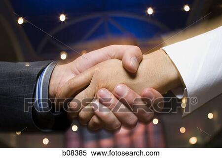 Close-up of a businessman and a businesswoman shaking hands View Large Photo Image Stock Photography - Close-up of a businessman and a businesswoman shaking hands. Fotosearch