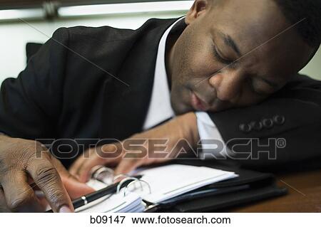 Close-up of a businessman sleeping View Large Photo Image Stock Photo - Close-up of a businessman sleeping. Fotosearch