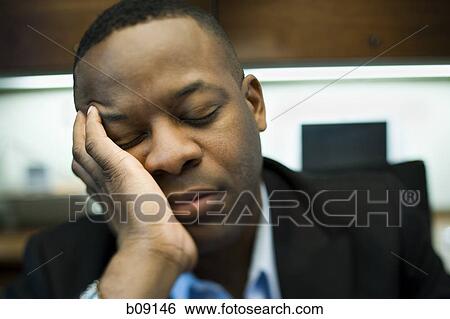 Close-up of a businessman sleeping with his head in his hands View Large Photo Image Stock Photograph - Close-up of a businessman sleeping with his head in his hands. Fotosearch