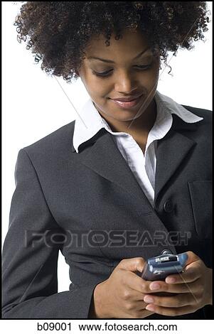 Close-up of a businesswoman holding a mobile phone View Large Photo Image Stock Image - Close-up of a businesswoman holding a mobile phone. Fotosearch