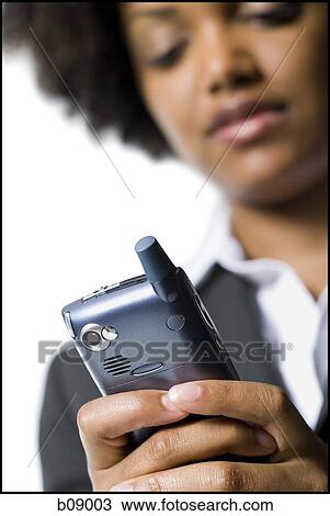 Close-up of a businesswoman holding a mobile phone View Large Photo Image Stock Image - Close-up of a businesswoman holding a mobile phone. Fotosearch