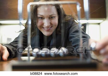 Close-up of a businesswoman looking at a pendulum View Large Photo Image Picture - Close-up of a businesswoman looking at a pendulum. Fotosearch