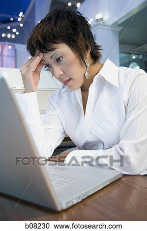 Stock Image - Close-up of a businesswoman using a laptop. Fotosearch