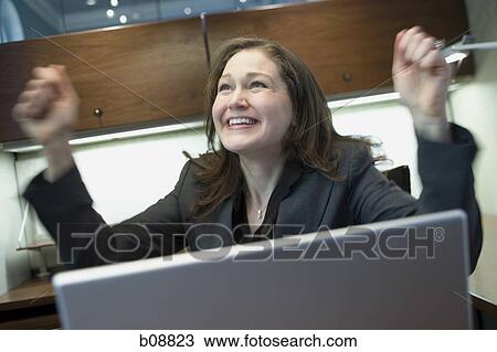 Close-up of a businesswoman with her arms raised View Large Photo Image Stock Image - Close-up of a businesswoman with her arms raised. Fotosearch