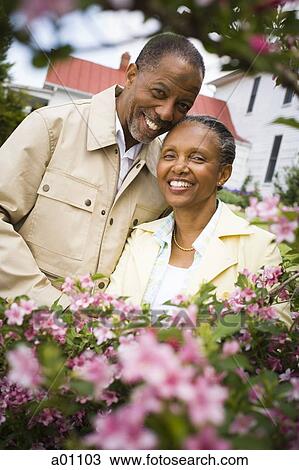 Close-up of a couple smiling View Large Photo Image Stock Image - Close-up of a couple smiling. Fotosearch