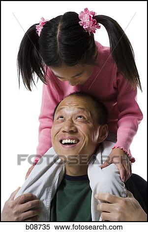 Close-up of a father with his daughter sitting on his shoulders View Large Photo Image Stock Photography - Close-up of a father with his daughter sitting on his shoulders. Fotosearch
