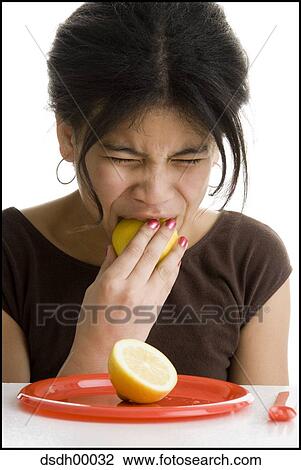 Close-up of a girl eating a lemon View Large Photo Image Stock Image - Close-up of a girl eating a lemon. Fotosearch