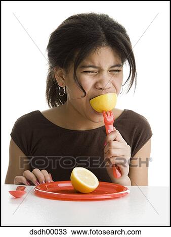 Close-up of a girl eating a lemon View Large Photo Image Stock Image - Close-up of a girl eating a lemon. Fotosearch