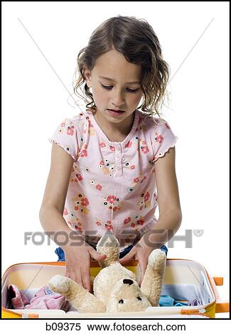 Close-up of a girl packing her suitcase View Large Photo Image Stock Photography - Close-up of a girl packing her suitcase. Fotosearch