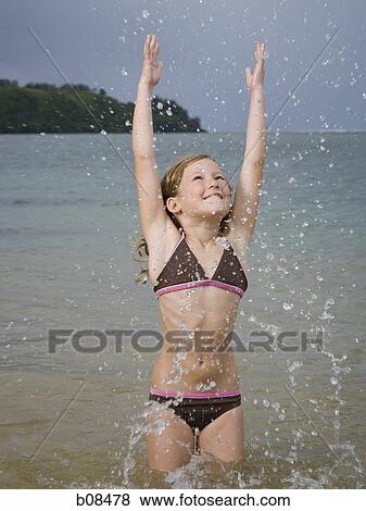 Close-up of a girl splashing water View Large Photo Image Stock Photo - Close-up of a girl splashing water. Fotosearch
