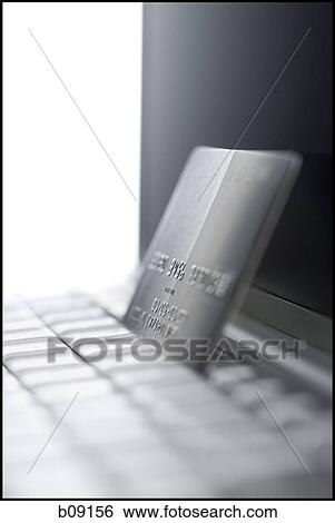 Stock Photograph - Close-up of a laptop and a credit card. Fotosearch