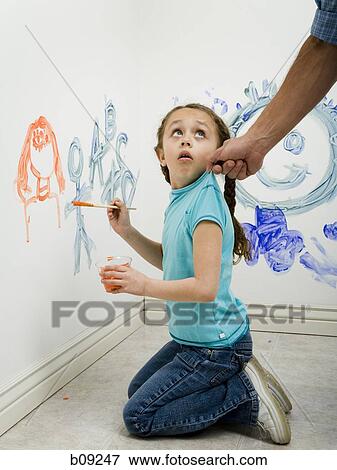 Close-up of a man pulling a girl's top while painting on a wall View Large Photo Image Stock Photo - Close-up of a man pulling a girl's top while painting on a wall. Fotosearch