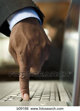 Close-up of a man's hand using a laptop View Large Photo Image Stock Photo - Close-up of a man's hand using a laptop. Fotosearch