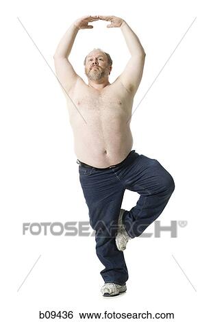 Stock Photograph - Close-up of a mature man standing on one leg. Fotosearch