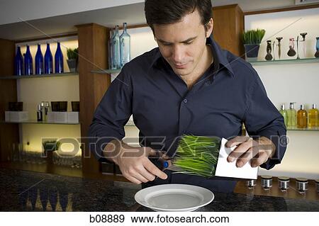 Close-up of a mid adult man cutting herbs with a pair of scissors View Large Photo Image Stock Photo - Close-up of a mid adult man cutting herbs with a pair of scissors. Fotosearch