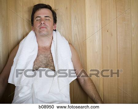 Close-up of a mid adult man sitting in a sauna with his eyes closed View Large Photo Image Stock Image - Close-up of a mid adult man sitting in a sauna with his eyes closed. Fotosearch