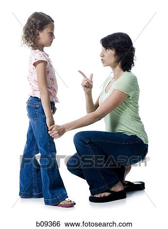 Close-up of a mid adult woman scolding her daughter View Large Photo Image Stock Photograph - Close-up of a mid adult woman scolding her daughter. Fotosearch