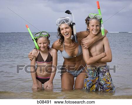 Stock Image - Close-up of a mother and her two children wearing scuba masks and snorkels. Fotosearch