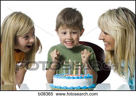 Close-up of a mother and her two children in front of a birthday cake View Large Photo Image Stock Photography - Close-up of a mother and her two children in front of a birthday cake. Fotosearch
