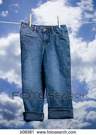 Close-up of a pair of jeans hanging on a clothesline View Large Photo Image Stock Image - Close-up of a pair of jeans hanging on a clothesline. Fotosearch