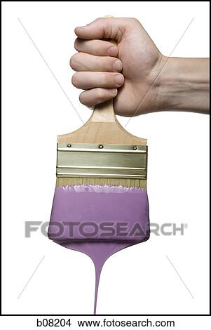 Close-up of a person's hand holding a paintbrush View Large Photo Image Picture - Close-up of a person's hand holding a paintbrush. Fotosearch