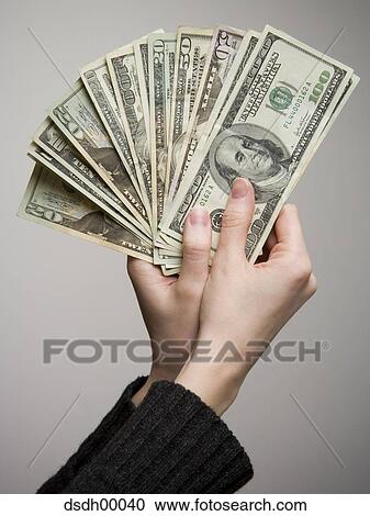 Close-up of a person's hand holding American paper currency View Large Photo Image Stock Image - Close-up of a person's hand holding American paper currency. Fotosearch