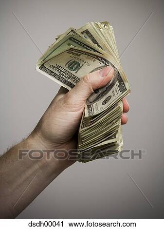 Close-up of a person's hand holding American paper currency View Large Photo Image Stock Image - Close-up of a person's hand holding American paper currency. Fotosearch
