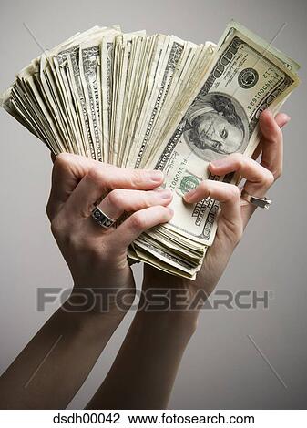 Close-up of a person's hand holding American paper currency View Large Photo Image Stock Image - Close-up of a person's hand holding American paper currency. Fotosearch