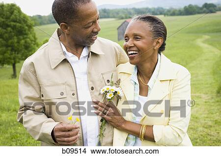 Picture - Close-up of a senior man and a senior woman smiling. Fotosearch