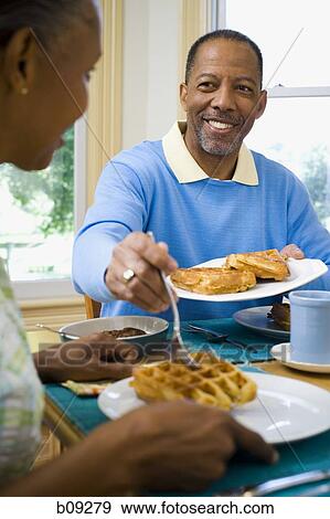 Close-up of a senior man and a senior woman having breakfast View Large Photo Image Stock Photo - Close-up of a senior man and a senior woman having breakfast. Fotosearch