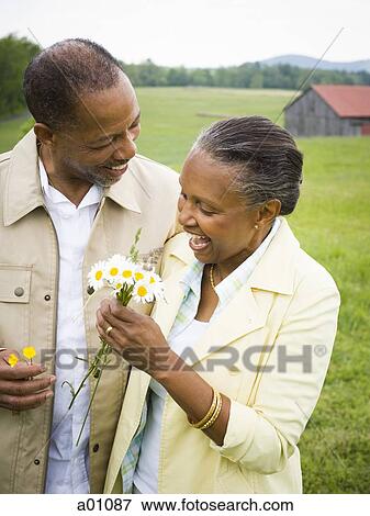 Close-up of a senior woman and a senior man standing and smiling View Large Photo Image Stock Photo - Close-up of a senior woman and a senior man standing and smiling. Fotosearch