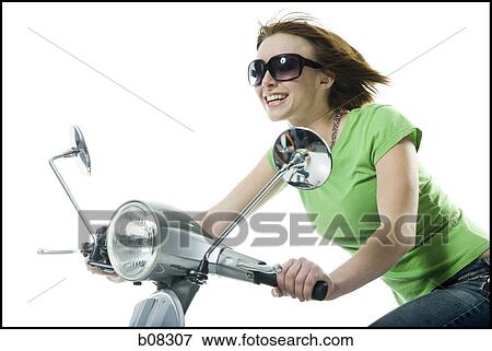 Close-up of a teenage girl riding a scooter View Large Photo Image Stock Photo - Close-up of a teenage girl riding a scooter. Fotosearch