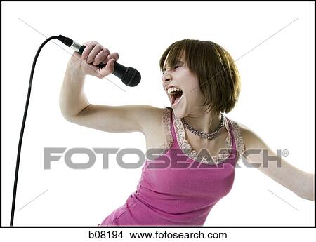 Close-up of a teenage girl singing into a microphone View Large Photo Image Picture - Close-up of a teenage girl singing into a microphone. Fotosearch