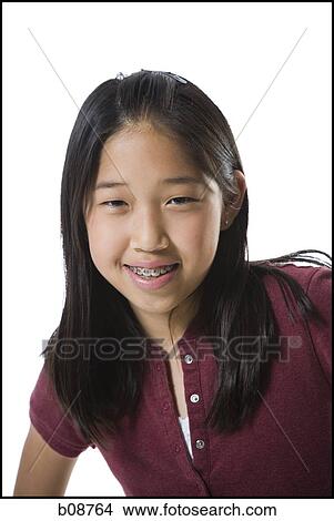 Close-up of a teenage girl smiling View Large Photo Image Picture - Close-up of a teenage girl smiling. Fotosearch