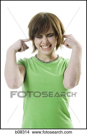Close-up of a teenage girl with her fingers in her ears View Large Photo Image Picture - Close-up of a teenage girl with her fingers in her ears. Fotosearch