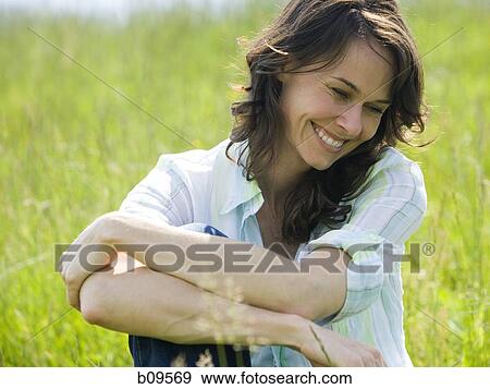 Close-up of a woman smiling with her arms crossed View Large Photo Image Stock Photo - Close-up of a woman smiling with her arms crossed. Fotosearch