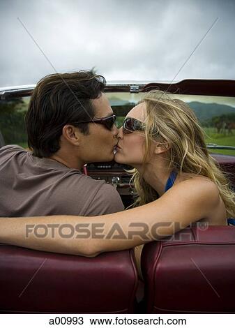 Close-up of a young couple kissing each other View Large Photo Image Stock Image - Close-up of a young couple kissing each other. Fotosearch