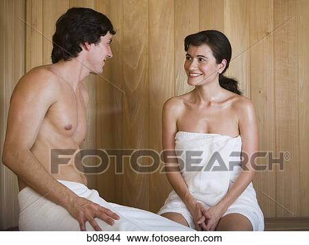 Close-up of a young couple looking at each other and sitting in a sauna View Large Photo Image Picture - Close-up of a young couple looking at each other and sitting in a sauna. Fotosearch