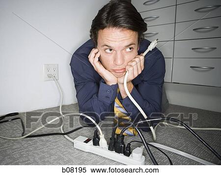 Close-up of a young man holding a plug View Large Photo Image Stock Photography - Close-up of a young man holding a plug. Fotosearch
