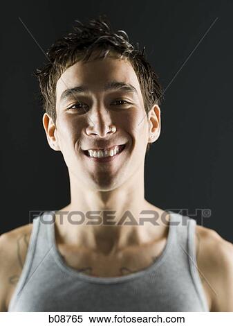 Close-up of a young man smiling View Large Photo Image Stock Photography - Close-up of a young man smiling. Fotosearch