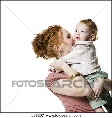 Close-up of a young woman carrying her baby girl View Large Photo Image Stock Photo - Close-up of a young woman carrying her baby girl. Fotosearch