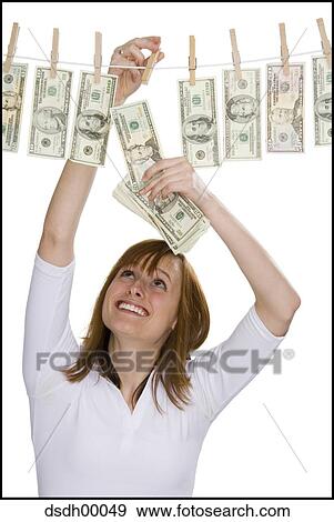 Close-up of a young woman drying dollar bills on a clothesline View Large Photo Image Stock Photo - Close-up of a young woman drying dollar bills on a clothesline. Fotosearch