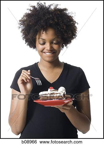 Close-up of a young woman holding a plate of cake View Large Photo Image Stock Photograph - Close-up of a young woman holding a plate of cake. Fotosearch