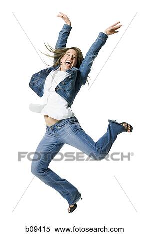 Stock Photography - Close-up of a young woman jumping in excitement. Fotosearch