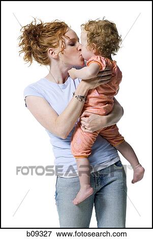 Stock Photo - Close-up of a young woman kissing her daughter. Fotosearch