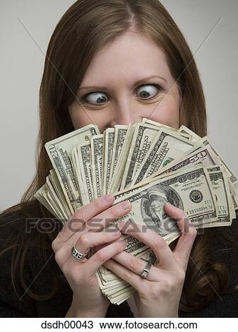 Close-up of a young woman looking at American paper currency View Large Photo Image Stock Image - Close-up of a young woman looking at American paper currency. Fotosearch